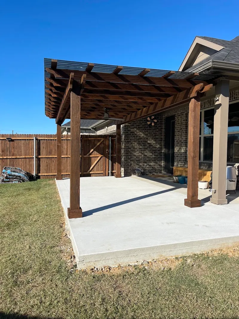 Side view of the stained pergola posts and polycarbonate roof panels in Gunter, Texas